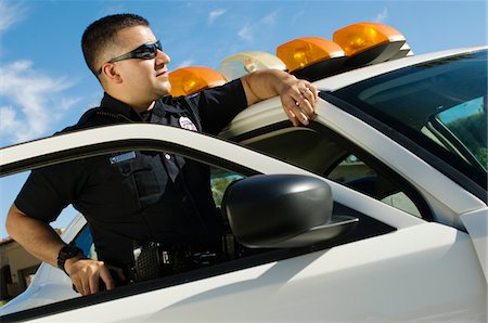 Police Officer Leaning on Patrol Car Stock Photo - Premium Royalty-Free, Code: 694-03328447