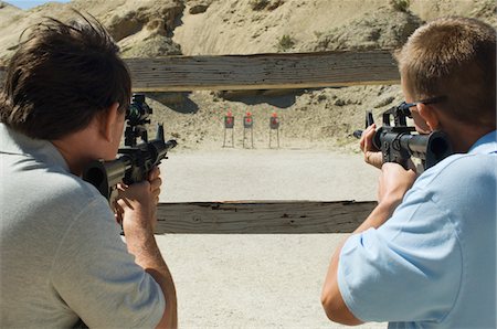 Men aiming rifles at firing range Stock Photo - Premium Royalty-Free, Code: 694-03328578