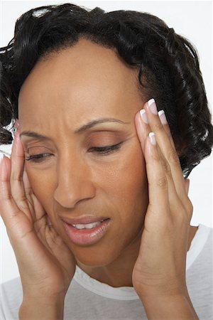 sick black woman - Woman with head in hands, close-up Stock Photo - Premium Royalty-Free, Code: 694-03329074