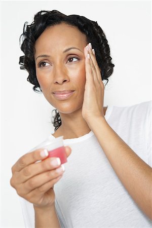 sick black woman - Woman taking medicine, with hand on head, close-up Stock Photo - Premium Royalty-Free, Code: 694-03329083