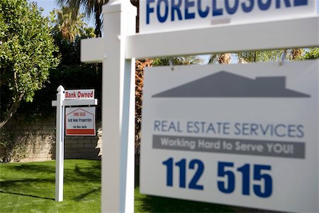 Real Estate Signs at Foreclosed Property Stock Photo - Premium Royalty-Free, Code: 694-03329126