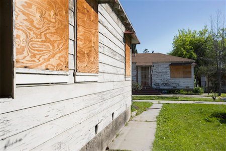 subdivision - Abandoned Houses With Boarded Up Windows Stock Photo - Premium Royalty-Free, Code: 694-03329224