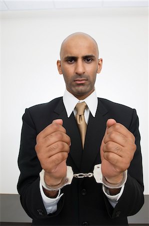 Businessman in Handcuffs Stock Photo - Premium Royalty-Free, Code: 694-03329896