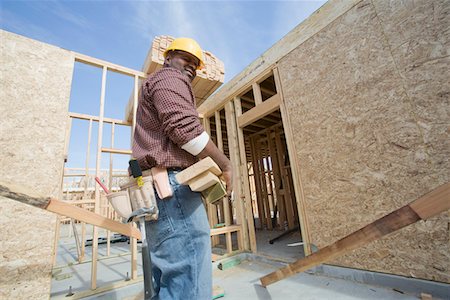 simsearch:693-06016727,k - Construction worker carrying wooden plank Stock Photo - Premium Royalty-Free, Code: 694-03321748