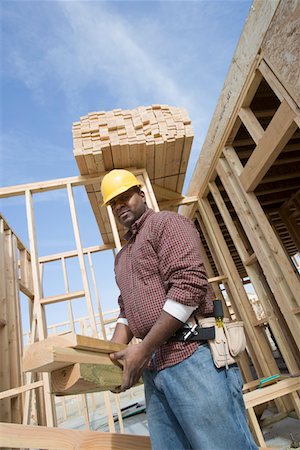 simsearch:693-06016727,k - Construction worker carrying wooden plank Stock Photo - Premium Royalty-Free, Code: 694-03321749
