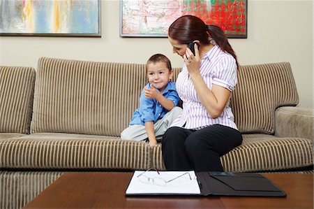 Businesswoman Working at Home with Son Stock Photo - Premium Royalty-Free, Code: 694-03330134