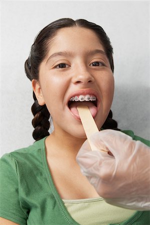 preteen girl with doctor - Nurse checking girls tongue in hospital Stock Photo - Premium Royalty-Free, Code: 694-03331508