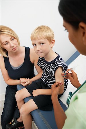 doctor injecting child - Mother supporting son receiving injection,elevated view Stock Photo - Premium Royalty-Free, Code: 694-03331672