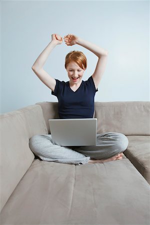 Woman using laptop on sofa Stock Photo - Premium Royalty-Free, Code: 694-03331769