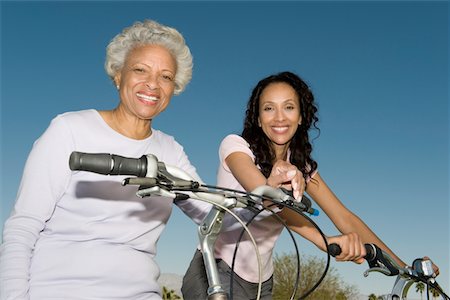 family mountain biking - Mother and daughter sit on mountain bikes Stock Photo - Premium Royalty-Free, Code: 694-03332084