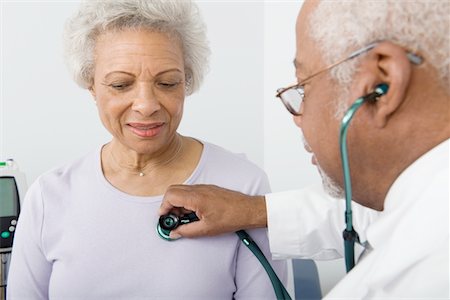 Senior healthcare professional examines female patient Stock Photo - Premium Royalty-Free, Code: 694-03332888