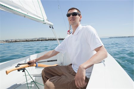 Young man sailing Stock Photo - Premium Royalty-Free, Code: 694-03474753
