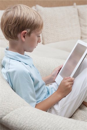 Boy reads a digital book Stock Photo - Premium Royalty-Free, Code: 694-03557955