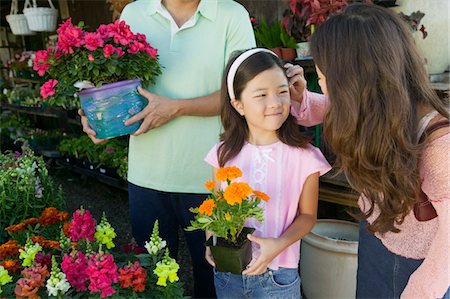 flower for mom asian - Mother fixing hair of daughter in plant nursery Stock Photo - Premium Royalty-Free, Code: 694-03692166