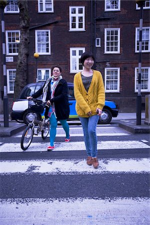 people at cross roads - Two female adults walking across the zebra crossing Stock Photo - Premium Royalty-Free, Code: 694-03783307