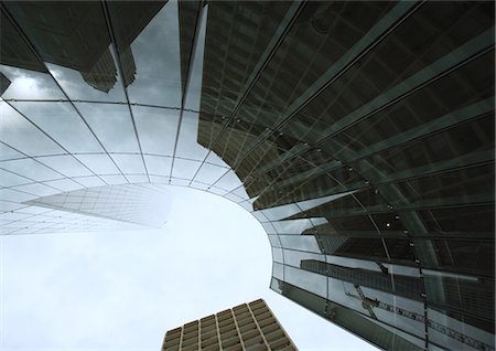 Skyscraper with reflection of buildings on facade, low angle, abstract view Stock Photo - Premium Royalty-Free, Code: 695-05764039
