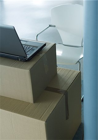 setup - Open laptop on stack of cardboard boxes, and empty chair Stock Photo - Premium Royalty-Free, Code: 695-05764159