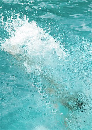 Surface of swimming pool splashing as swimmer moves underneath Stock Photo - Premium Royalty-Free, Code: 695-05764250