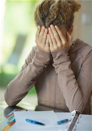 discourage - Preteen girl doing homework, covering face Stock Photo - Premium Royalty-Free, Code: 695-05764321