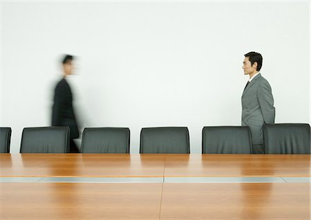 Businessman standing, facing associate arriving in conference room Stock Photo - Premium Royalty-Free, Code: 695-05764935