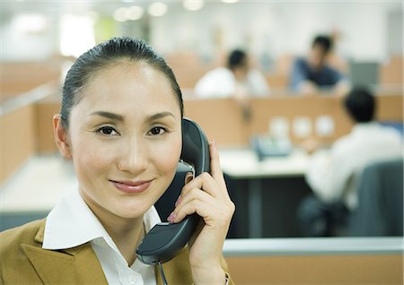 switchboard operator - Businesswoman using phone in office Stock Photo - Premium Royalty-Free, Code: 695-05764943