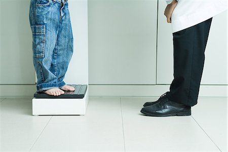 simsearch:632-01613036,k - Boy standing on scale, across from doctor, waist down Stock Photo - Premium Royalty-Free, Code: 695-05765419