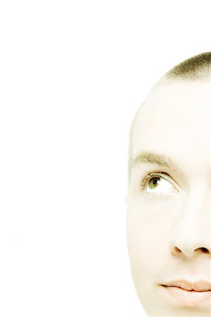 Young man's face, looking up, extreme close-up Stock Photo - Premium Royalty-Free, Code: 695-05765713