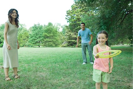 Family playing with plastic disc Stock Photo - Premium Royalty-Free, Code: 695-05765935