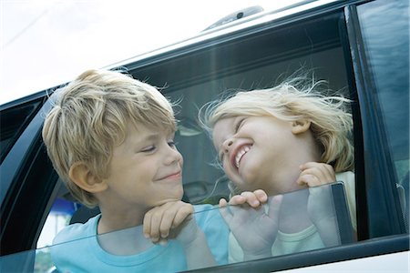 Children sticking heads out of car window Stock Photo - Premium Royalty-Free, Code: 695-05766045