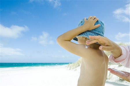 prevention - Mother putting sunscreen on child at beach Stock Photo - Premium Royalty-Free, Code: 695-05766111