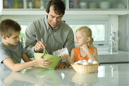 Father cooking with son and daughter Stock Photo - Premium Royalty-Free, Code: 695-05766371
