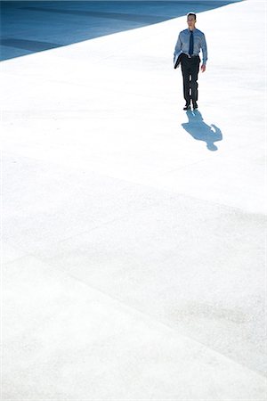 soul patch - Businessman walking outdoors, full length, mid-distance Stock Photo - Premium Royalty-Free, Code: 695-05766577