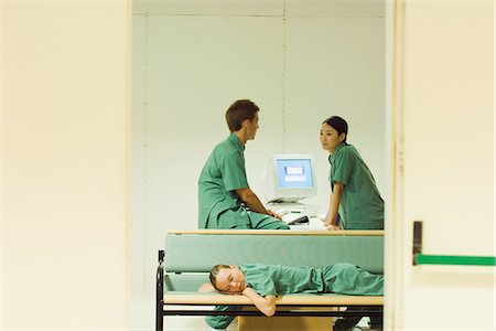 doctor intern male white - Medical workers chatting in office, one lying down on bench, eyes closed Stock Photo - Premium Royalty-Free, Code: 695-05766647
