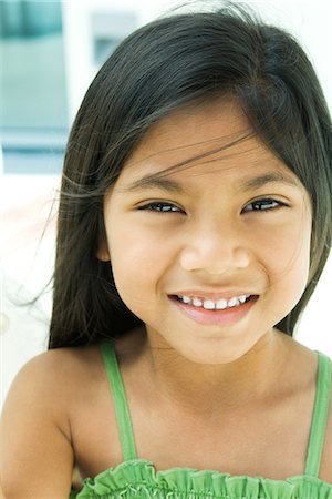 polynesian ethnicity - Girl smiling at camera, tousled hair, portrait Stock Photo - Premium Royalty-Free, Code: 695-05767003