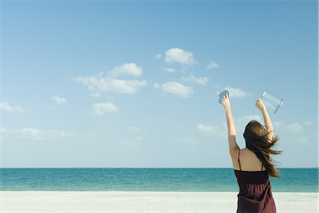 Woman catching clouds in container Stock Photo - Premium Royalty-Free, Code: 695-05767197