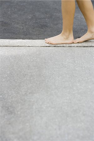 simsearch:695-03378125,k - Child walking along crack in sidewalk, cropped view of feet Stock Photo - Premium Royalty-Free, Code: 695-05767225