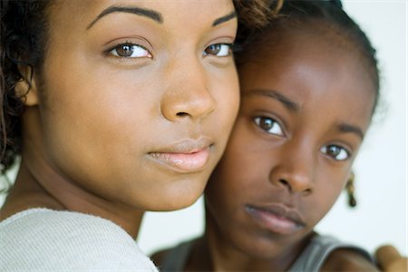 Mother and daughter embracing, looking at camera, cropped view Stock Photo - Premium Royalty-Free, Code: 695-05767448