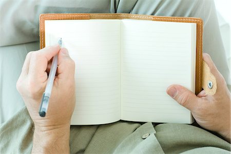 personal perspective - Man writing in diary, cropped view of hands Stock Photo - Premium Royalty-Free, Code: 695-05767594
