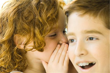 pictures of a little girl whispering - Little girl whispering in her brother's ear, close-up Stock Photo - Premium Royalty-Free, Code: 695-05767830