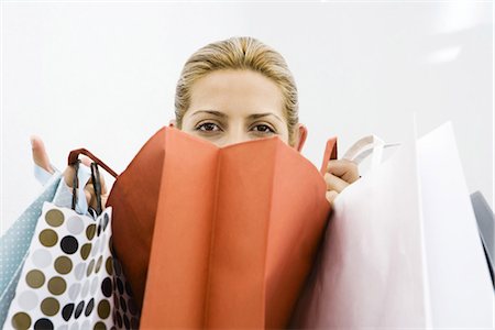 shopping bags closeup - Woman looking over several shopping bags Stock Photo - Premium Royalty-Free, Code: 695-05767935