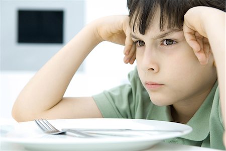 simsearch:695-03380694,k - Boy sulking at dinner table, close-up Stock Photo - Premium Royalty-Free, Code: 695-05768030