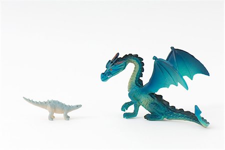 Toy dinosaur and toy dragon, face to face Stock Photo - Premium Royalty-Free, Code: 695-05768208