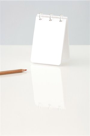 pad of paper - Notepad upright on table, cropped view of pencil nearby Stock Photo - Premium Royalty-Free, Code: 695-05768475