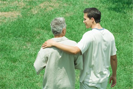 Father and adult son walking together outdoors, rear view Stock Photo - Premium Royalty-Free, Code: 695-05768562