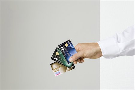 people holding cards in hand - Hand holding several credit cards Stock Photo - Premium Royalty-Free, Code: 695-05768927