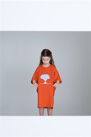 Little girl wearing tee-shirt with mushroom cloud printed on it Stock Photo - Premium Royalty-Free, Code: 695-05769004