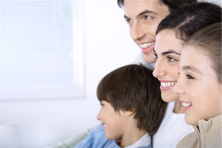 simsearch:695-05769087,k - Family sitting together, looking away, side view Stock Photo - Premium Royalty-Free, Code: 695-05769088