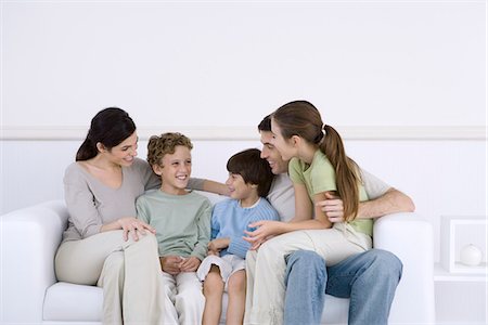 simsearch:695-05769087,k - Family with three children sitting together on sofa, talking Stock Photo - Premium Royalty-Free, Code: 695-05769095