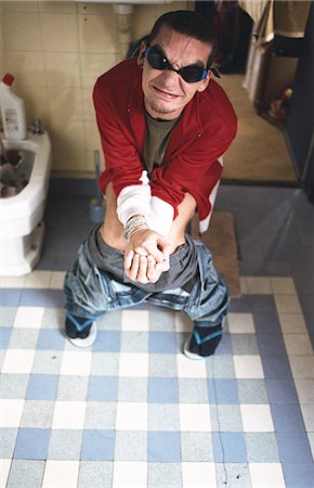 digestive system - Man using toilet, grimacing Stock Photo - Premium Royalty-Free, Code: 695-05769366
