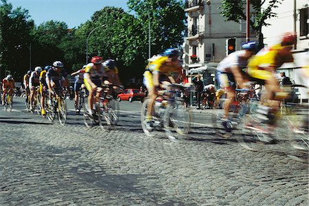 road cycling - Cyclists racing on cobblestone street Stock Photo - Premium Royalty-Free, Code: 695-05769536